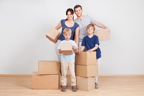 Moving crew handling a flat relocation in Highbury with careful stair access