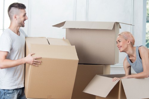 Local moving team handling boxes and furniture near Highbury