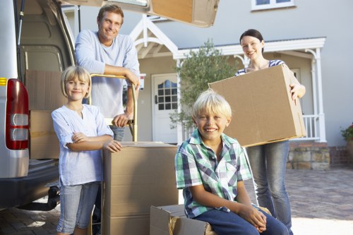Professional man and van in Highbury handling boxed belongings