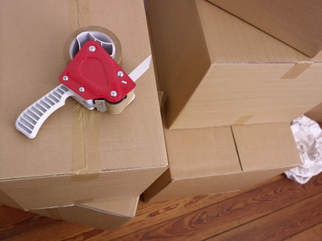Furniture being carried carefully through a narrow staircase during a local house move