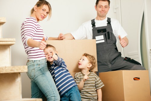 Professional movers handling office furniture during a Highbury relocation